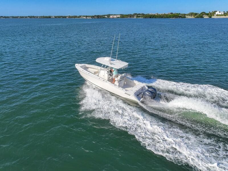 2018 Jupiter 26 FS boat cruising on open water, creating a wake.