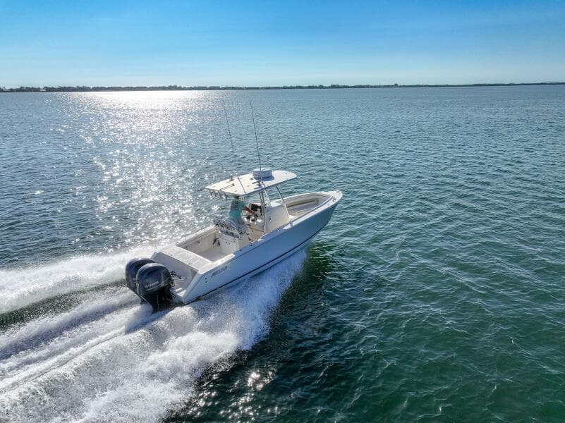 2018 Jupiter 26 FS boat cruising on open water under clear blue sky.