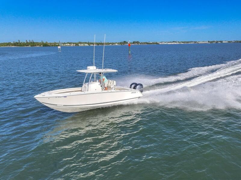 2018 Jupiter 26 FS boat cruising on open water under clear blue sky.