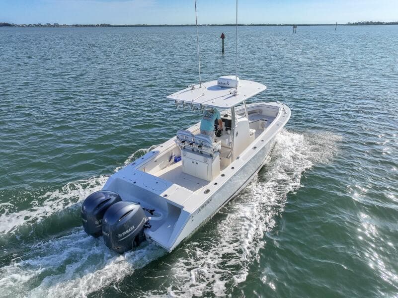 2018 Jupiter 26 FS boat cruising on open water with twin engines.