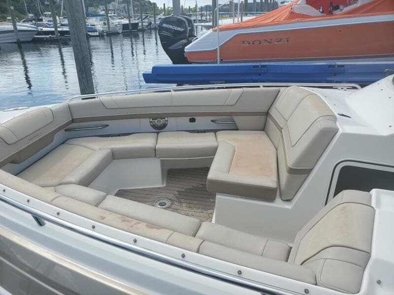 2015 Formula 330 Crossover Bowrider with spacious seating at a marina.