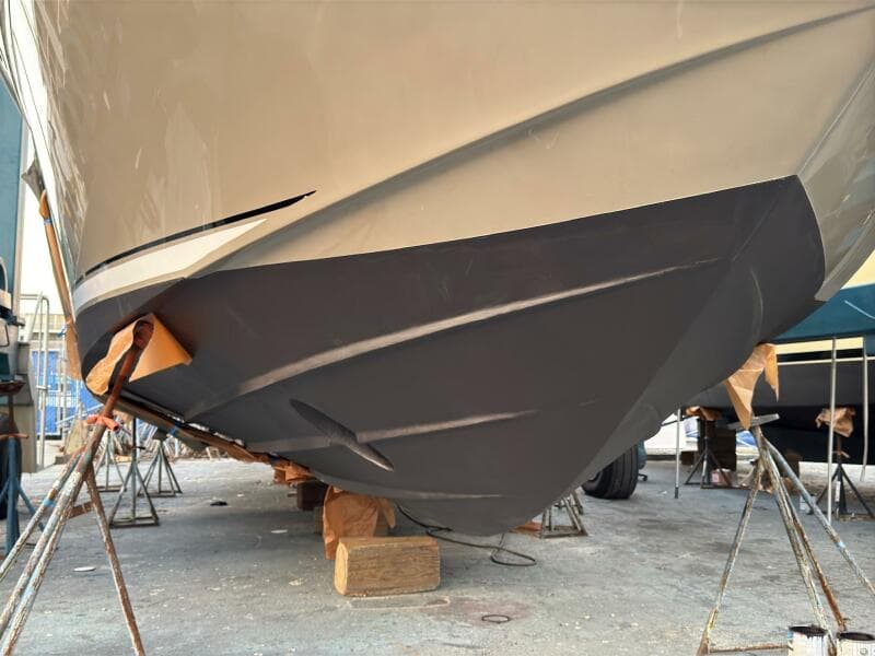 2005 Sea Ray 500 Sedan Bridge boat hull on dry dock for maintenance.