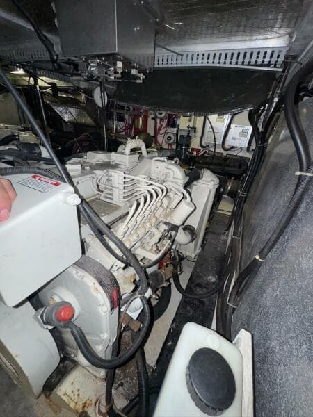 Engine room of a 2000 Carver 506 Motor Yacht, showcasing mechanical components and wiring.