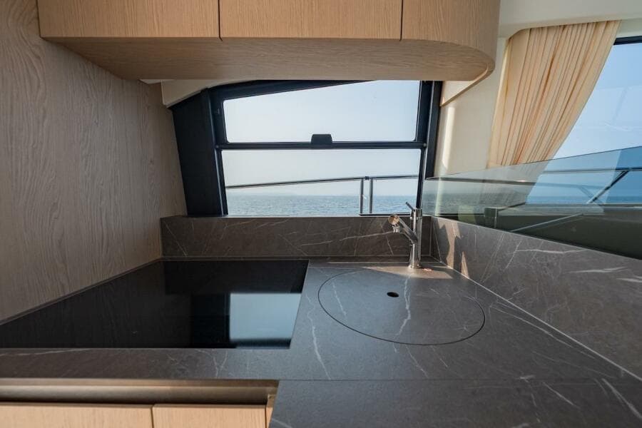 Modern kitchen interior on 2023 Azimut Fly 53 yacht with ocean view.
