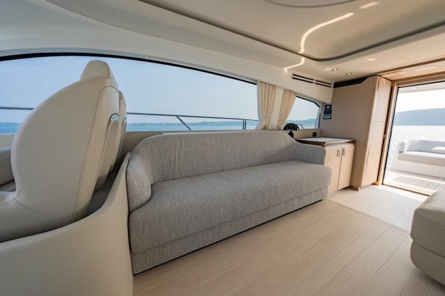 Luxurious interior of 2023 Azimut Fly 53 yacht with elegant seating and panoramic windows.