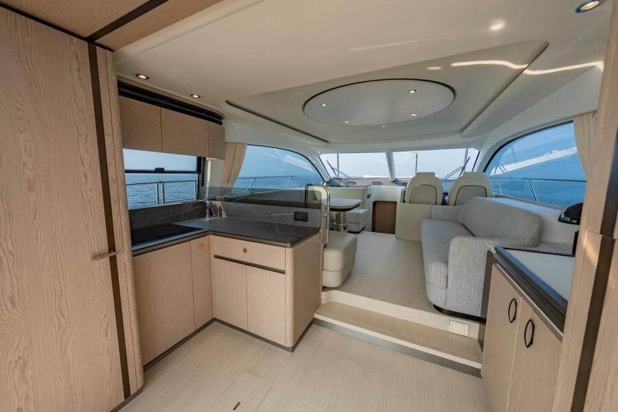 Luxurious interior of 2023 Azimut Fly 53 yacht with modern kitchen and seating area.