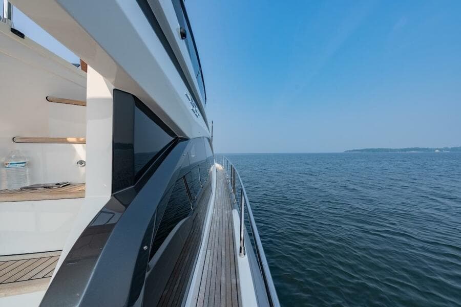 2023 Azimut Fly 53 yacht cruising on open water under clear blue sky.