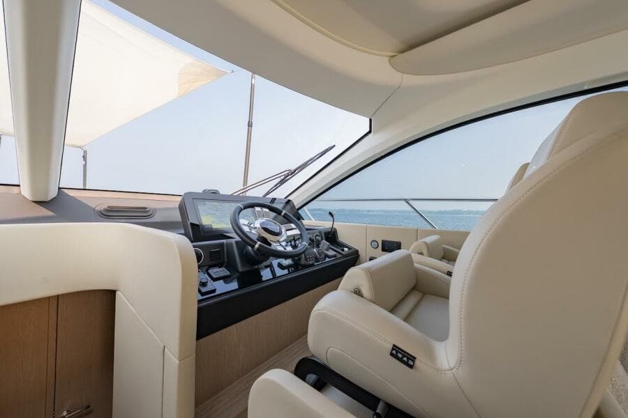 Luxurious interior of 2023 Azimut Fly 53 yacht with modern steering and plush seating.