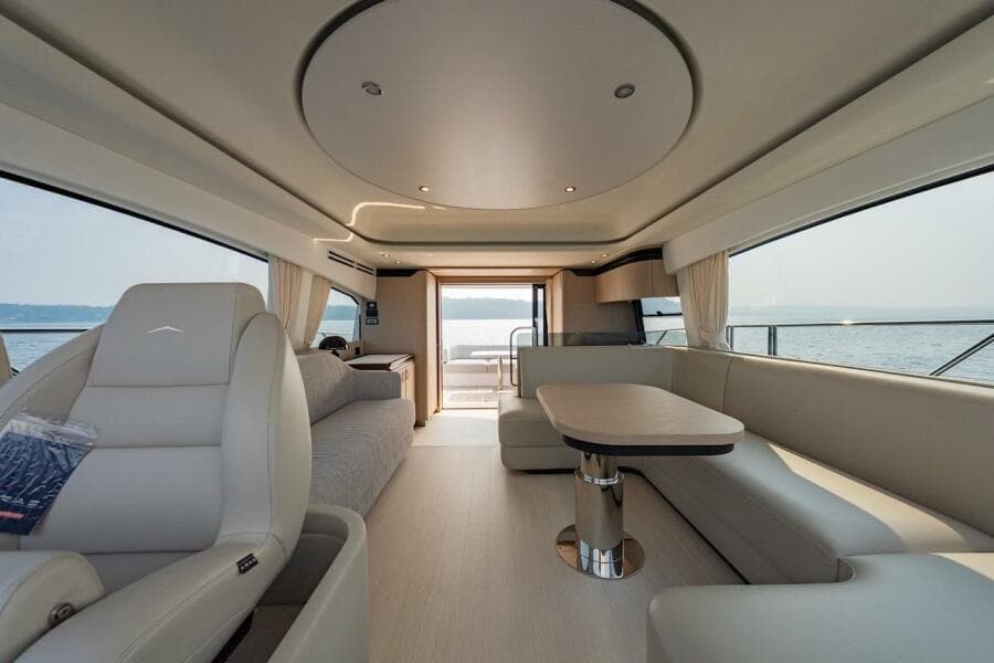 Luxurious interior of 2023 Azimut Fly 53 yacht with elegant seating and panoramic windows.