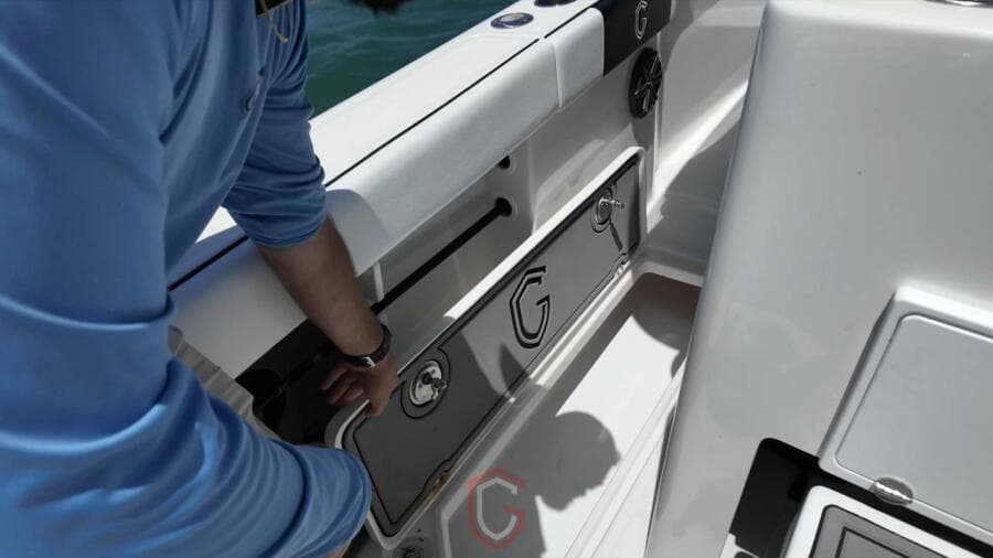 2023 CG Boat Works 35 M-Series interior detail with person adjusting compartment.