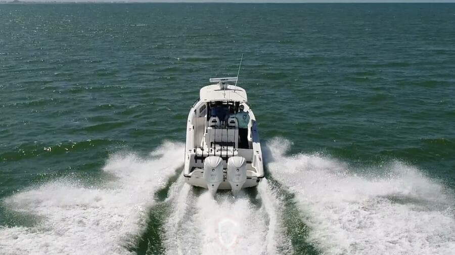 2023 CG Boat Works 35 M-Series cruising on open water, rear view.
