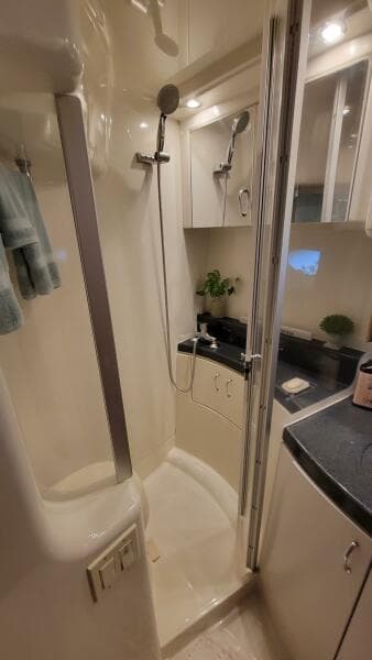 2004 Carver 360 Sport Sedan bathroom with shower, modern fixtures, and sleek cabinetry.
