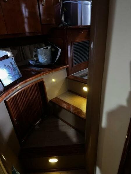 Interior of 2004 Carver 360 Sport Sedan with wooden stairs and ambient lighting.