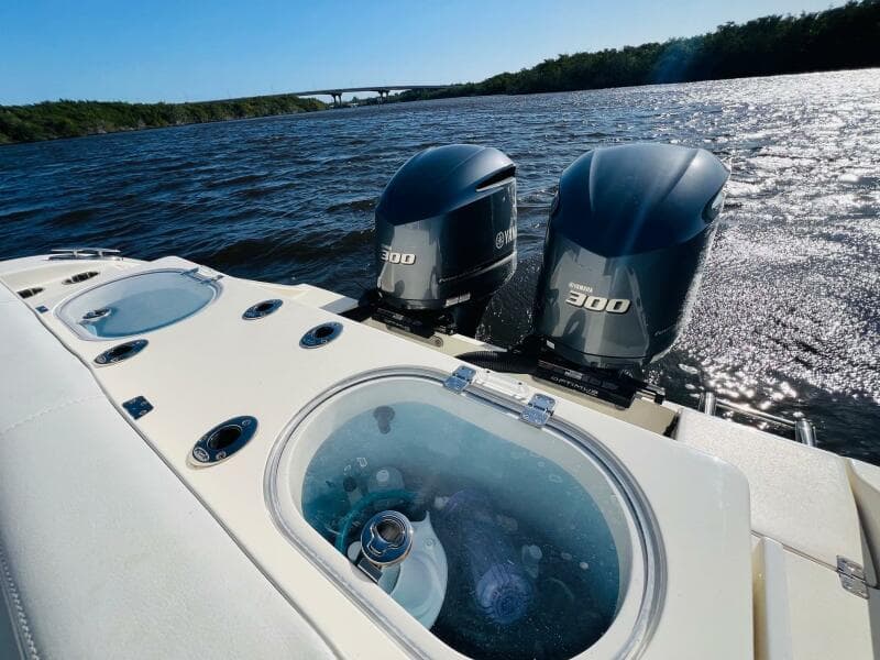 2021 Cobia 301 Center Console boat with twin 300 engines on a sunny day.