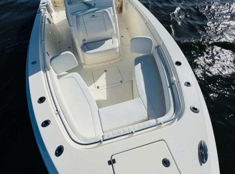 2021 Cobia 301 Center Console boat with spacious seating on calm water.