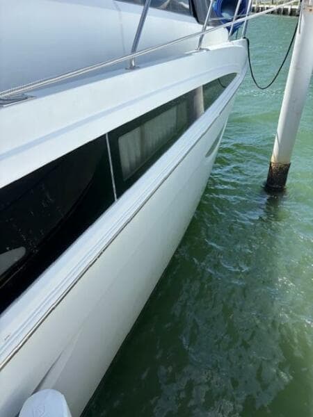 2006 Carver 43 Motor Yacht docked in clear water, side view.