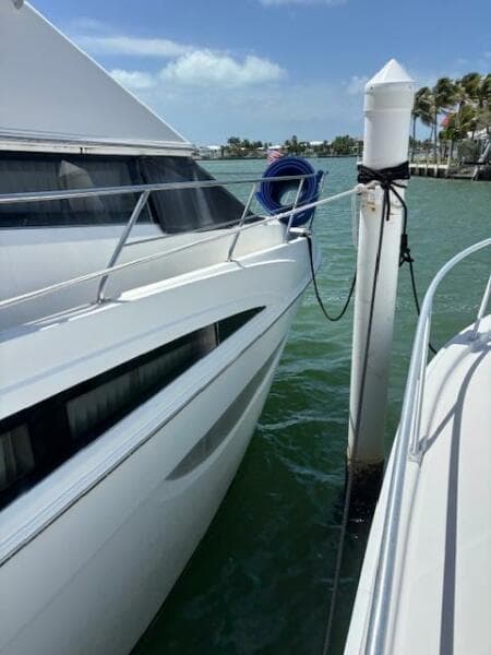 2006 Carver 43 Motor Yacht docked, sunny day, calm waters, blue sky.
