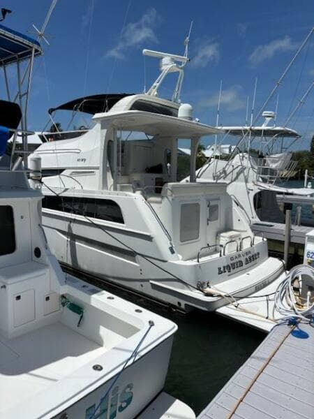 2006 Carver 43 Motor Yacht docked at marina under clear blue sky.