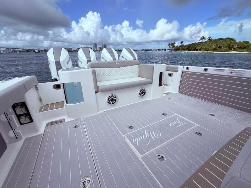 2024 Scout 400 LXF boat deck with seating, ocean view, and clear skies.