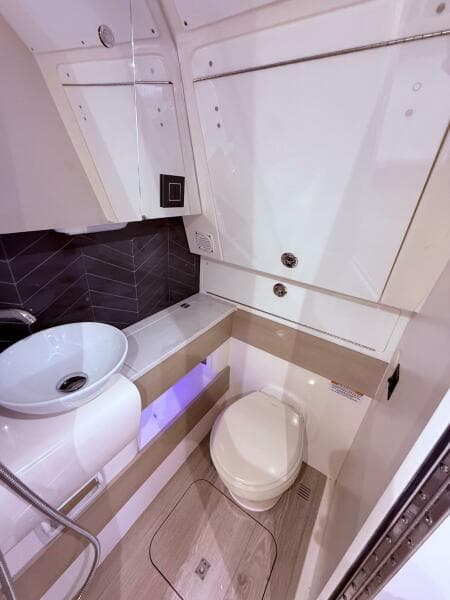 2024 Scout 400 LXF boat bathroom with modern sink and toilet.