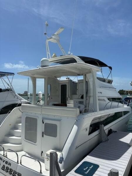 2006 Carver 43 Motor Yacht docked under clear blue sky.