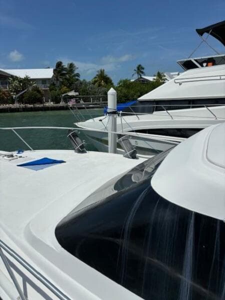 2006 Carver 43 Motor Yacht docked in a sunny marina setting.