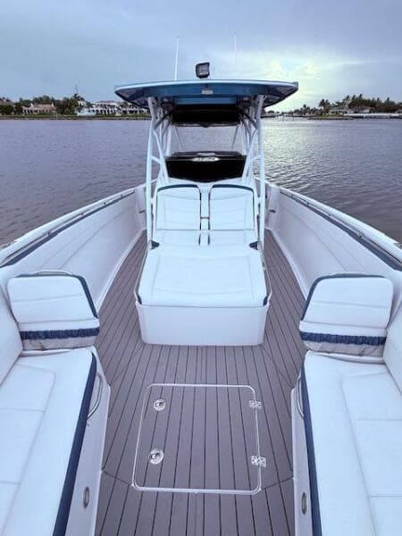 2022 Nor-Tech 390 Sport Center Console boat with spacious seating on calm water.
