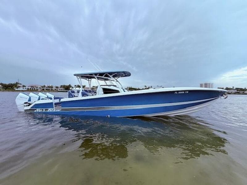 2022 Nor-Tech 390 Sport Center Console boat in calm waters, showcasing sleek blue design.