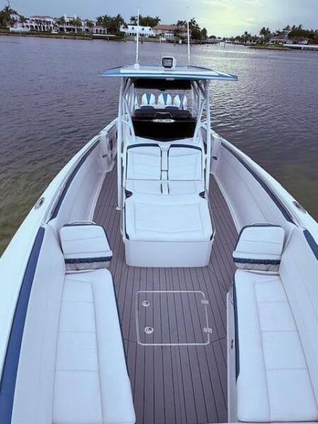 2022 Nor-Tech 390 Sport Center Console boat with spacious seating on calm water.