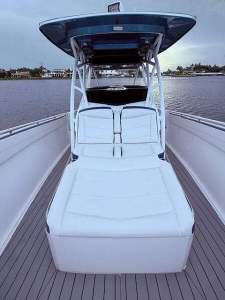 2022 Nor-Tech 390 Sport Center Console boat with sleek seating on calm water.