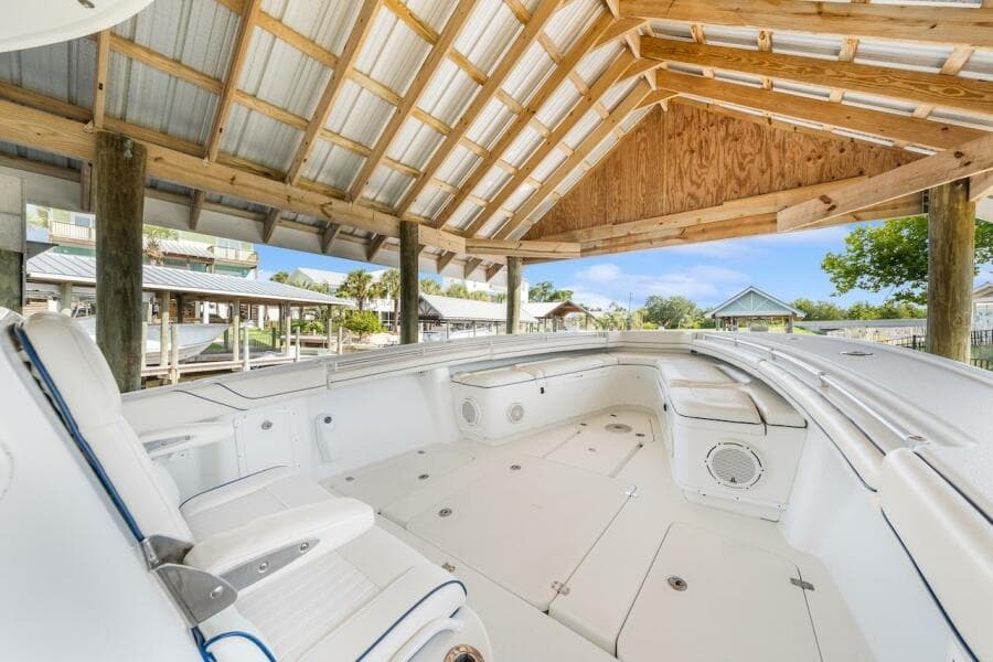 2015 Yellowfin 39 boat under wooden shelter, showcasing spacious seating and sleek design.