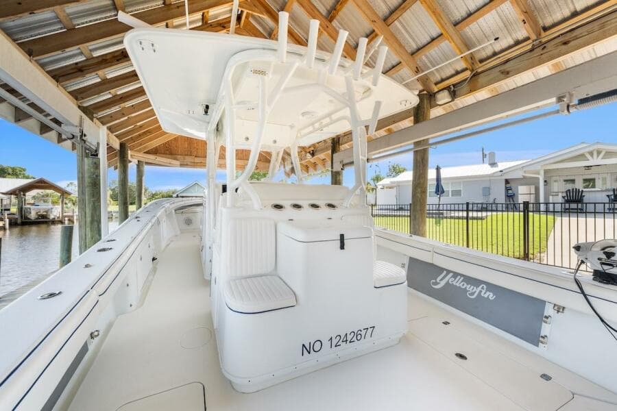 2015 Yellowfin 39 boat docked under a wooden canopy, showcasing sleek design and spacious deck.