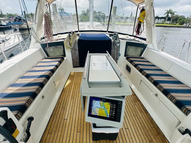 2015 Beneteau Oceanis 45 yacht cockpit with striped seating and navigation equipment.