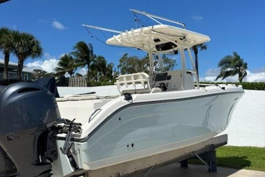 2018 Century 2600 Center Console boat on trailer, with clear blue sky background.