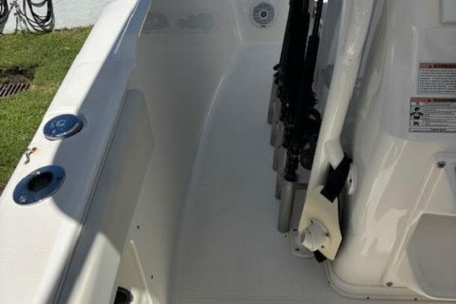 2018 Century 2600 Center Console boat interior with rod holders and seating area.
