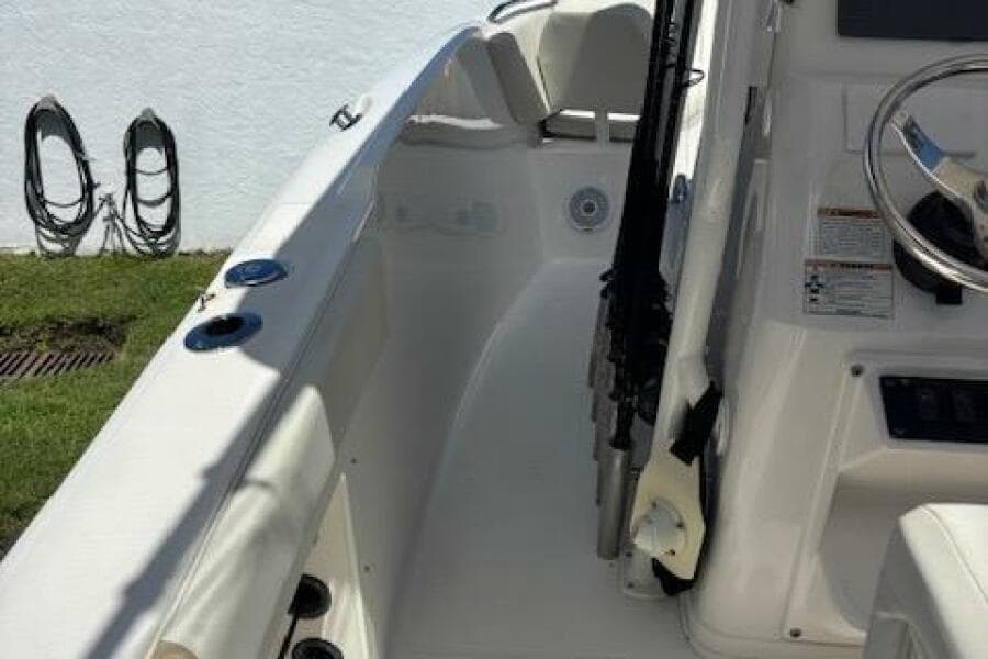 2018 Century 2600 Center Console boat interior with steering wheel and rod holders.
