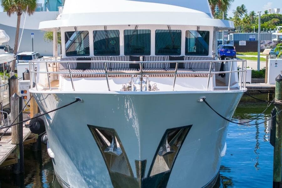 Luxury yacht ABD 90 Explorer 1996 docked at marina, sunny day, palm trees in background.