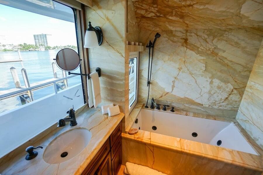 Luxurious marble bathroom on 1996 ABD 90 Explorer yacht with waterfront view.