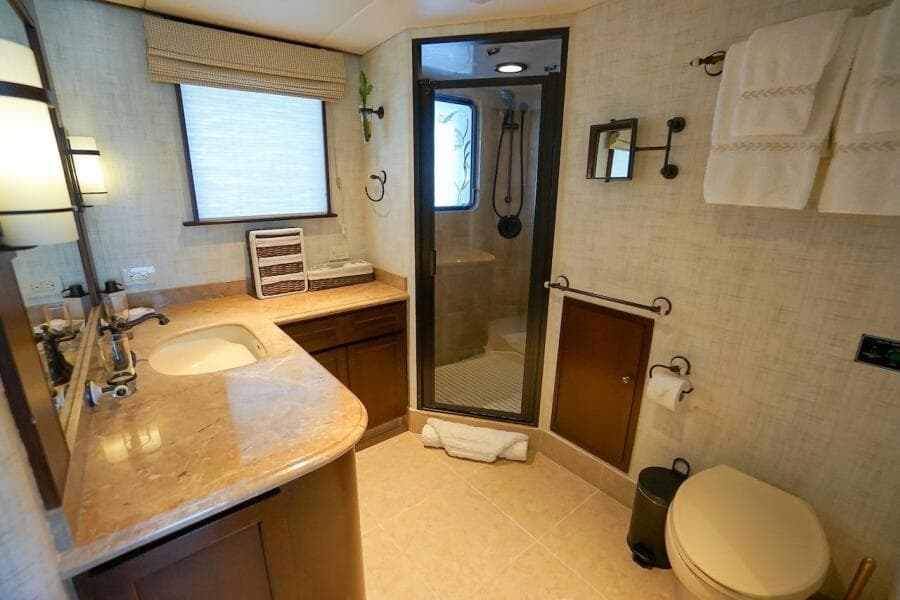 Luxurious 1996 ABD 90 Explorer yacht bathroom with marble countertop and glass shower.
