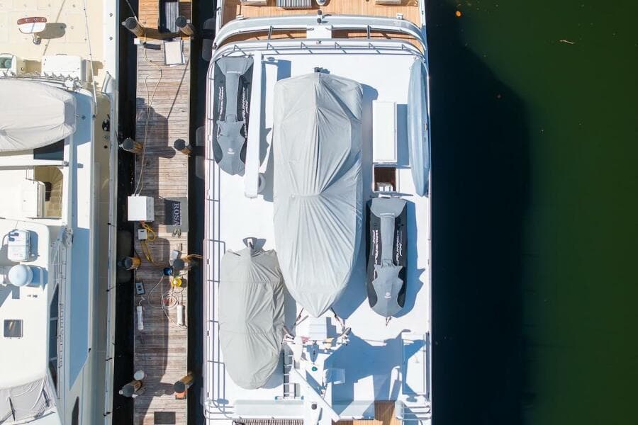 Aerial view of 1996 ABD 90 Explorer yacht docked with covered equipment.