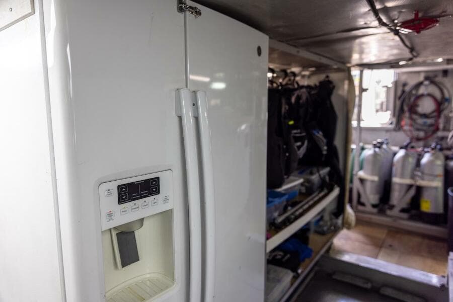 Refrigerator in a storage area with scuba gear and tanks, ABD 90 Explorer, 1996.