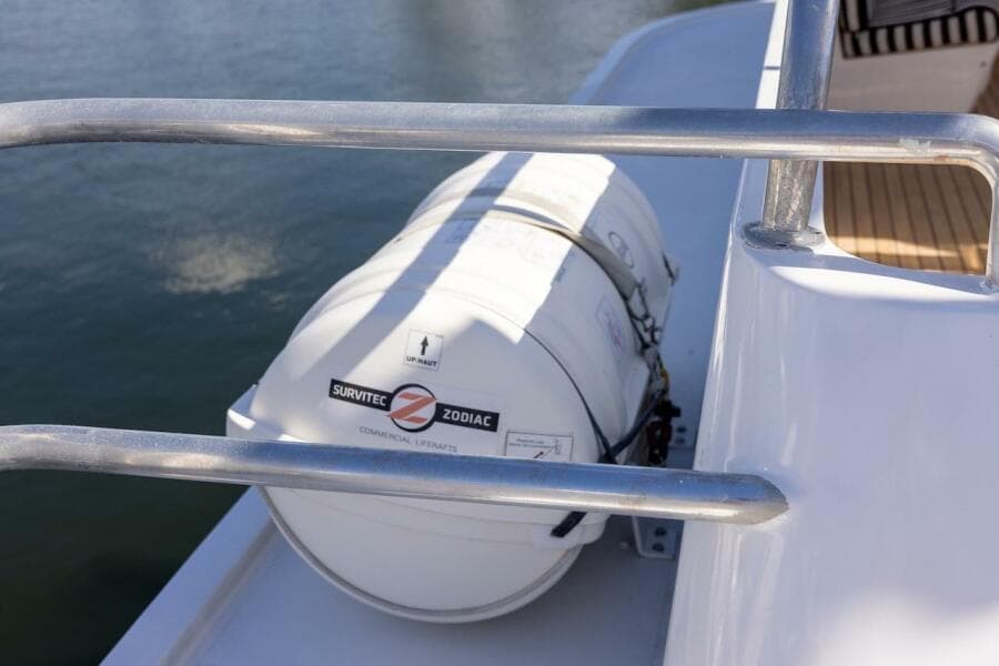 Liferaft on 1996 ABD 90 Explorer yacht deck, near water.
