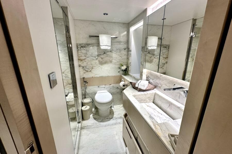 Luxurious marble bathroom in 2023 Majesty 120 yacht, featuring modern fixtures and elegant design.