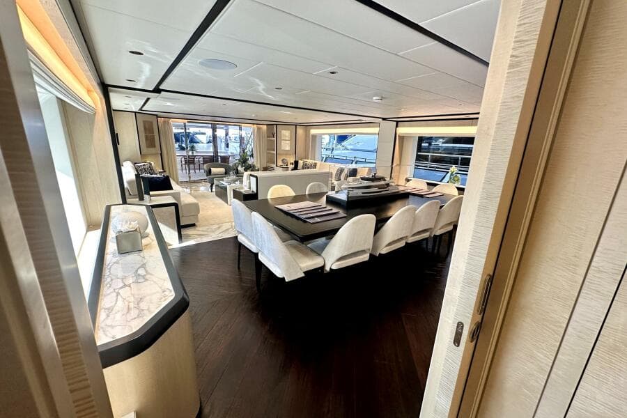 Luxurious interior of 2023 Majesty 120 yacht with elegant dining and seating areas.