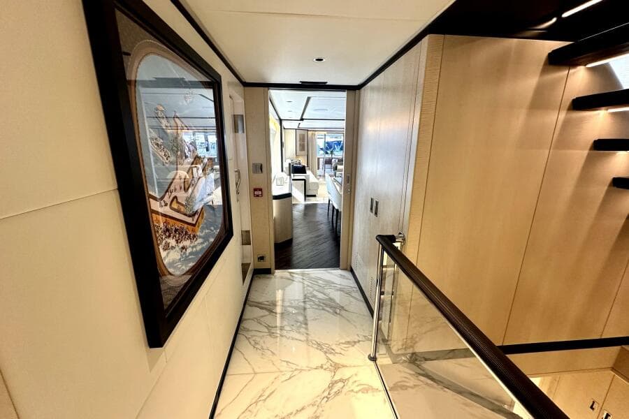 Luxurious interior hallway of 2023 Majesty 120 yacht with elegant decor and marble flooring.