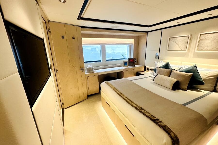 Luxurious bedroom interior of 2023 Majesty 120 yacht, featuring elegant decor and modern amenities.
