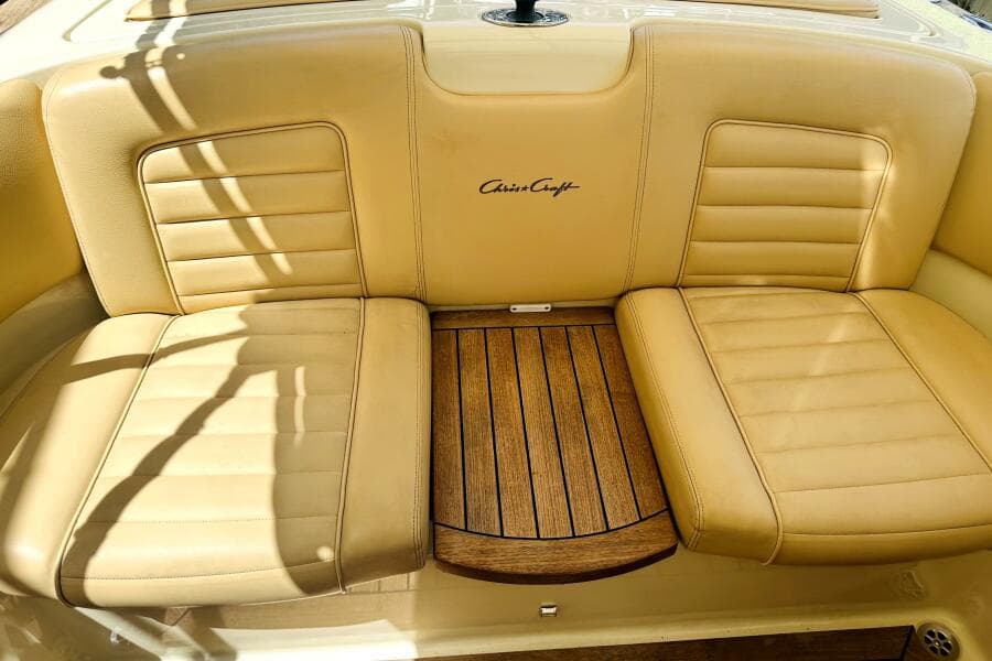 Luxurious tan leather seating on 2013 Chris-Craft Corsair 22 boat with wooden accents.