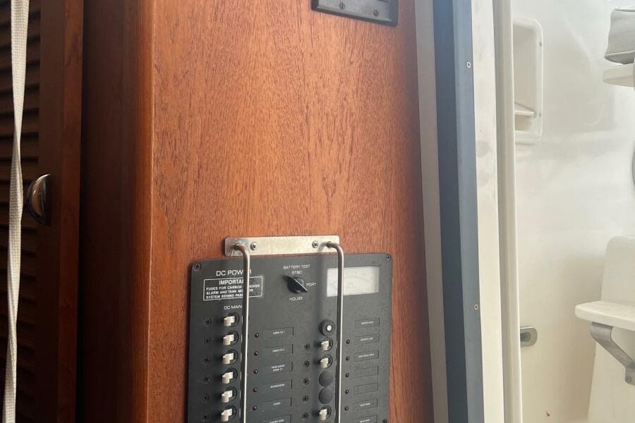 Control panel on 2001 Pursuit 3000 Offshore boat, featuring wooden finish and switches.