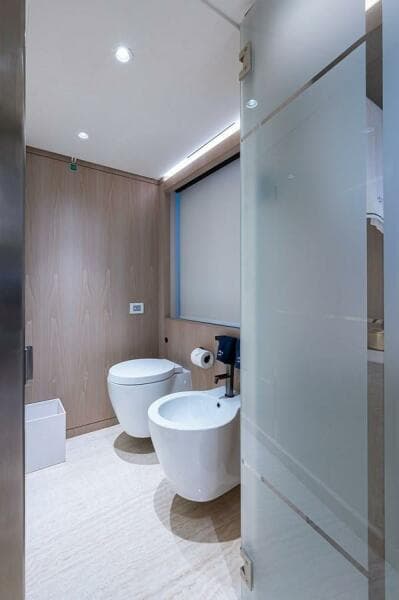 Modern bathroom with toilet and bidet on Majesty 140 yacht, 2020 model.