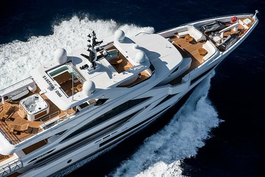 Luxurious 2020 Majesty 140 yacht cruising on open water, aerial view.